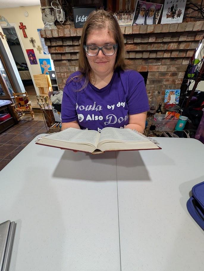 Melanie reading a book at a table