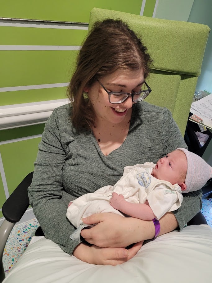 Doula Melanie Powell enjoying a tender moment with a newborn baby