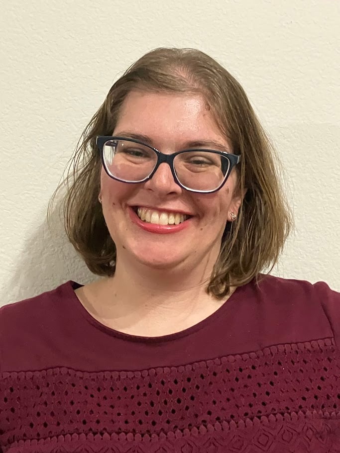 Doula Melanie Powel smiling wearing a maroon shirt 